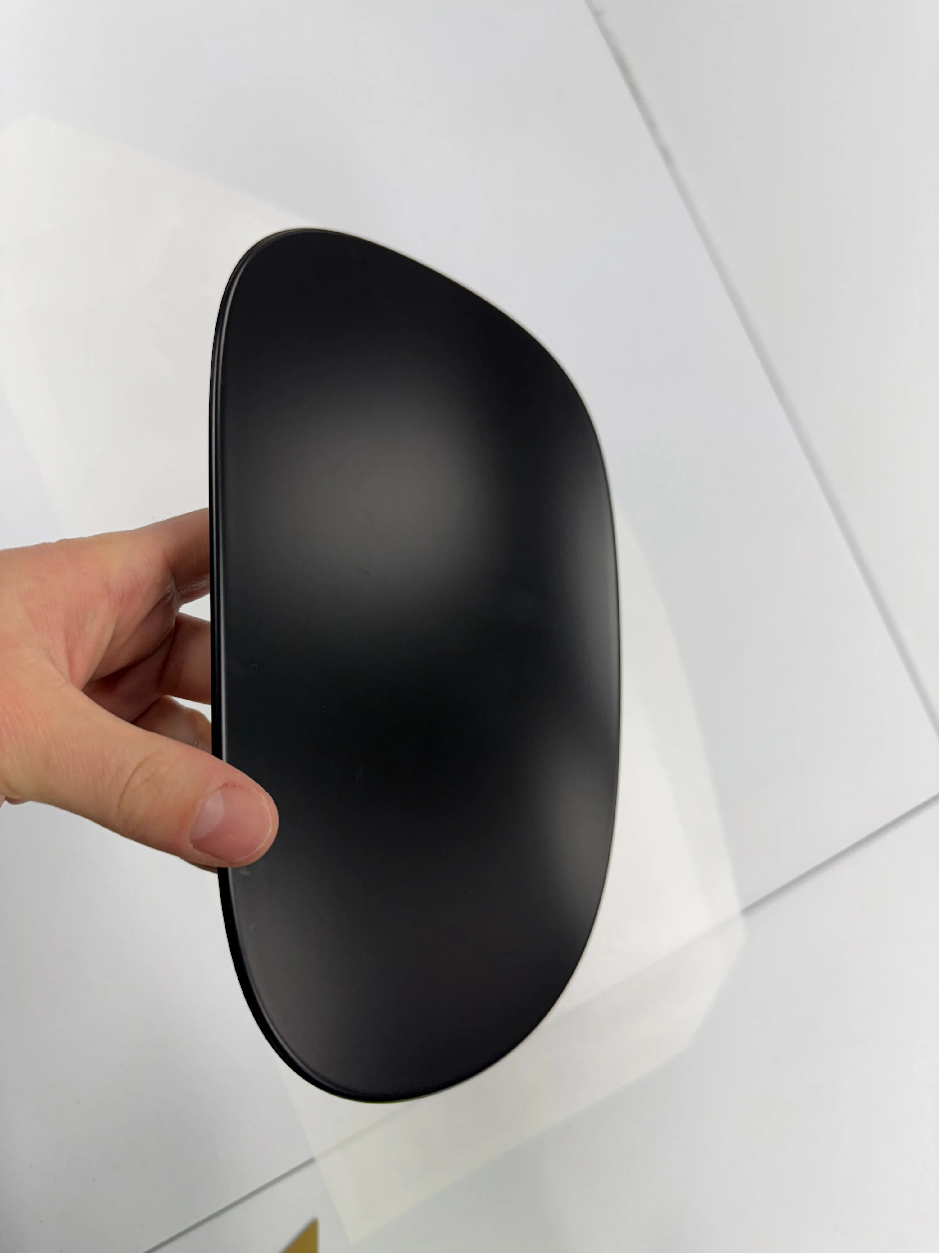 Fuel door cap wrapped in paint protection film, removed from the vehicle for complete edge-to-edge coverage