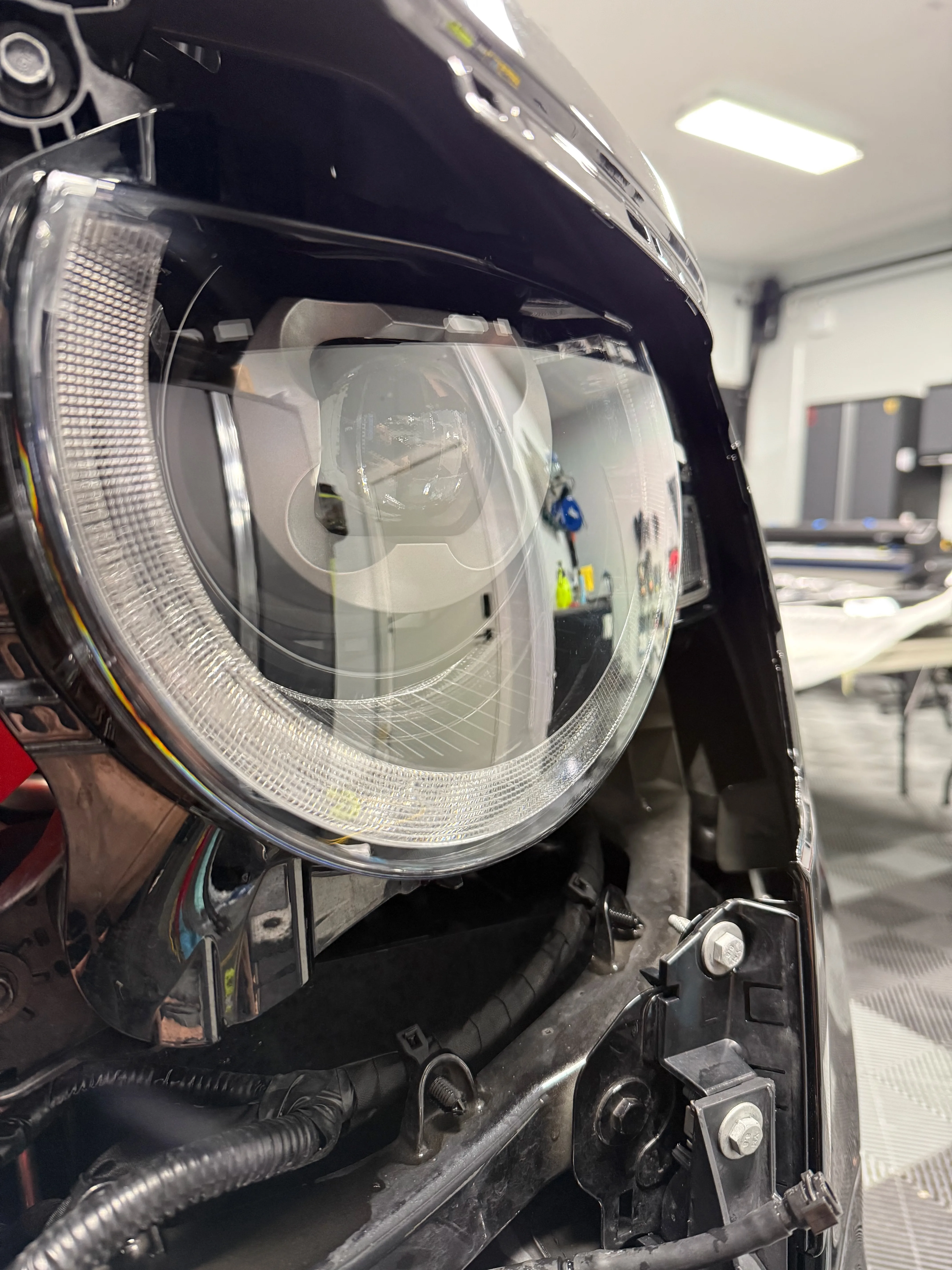 Headlight after PPF installation — optically clear protection with clean edges